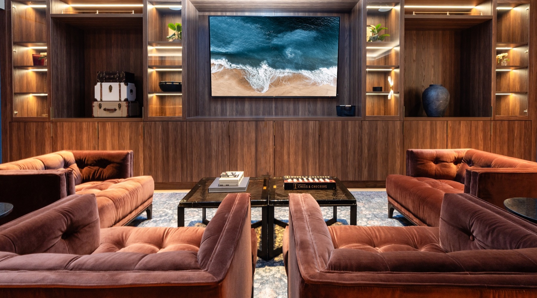 two arm chairs facing a television in a lounge