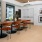 large table and seating in a room with windows pillar and art on the wall