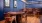 a game room with a poker table and bar with seating