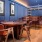 a game room with a poker table and bar with seating